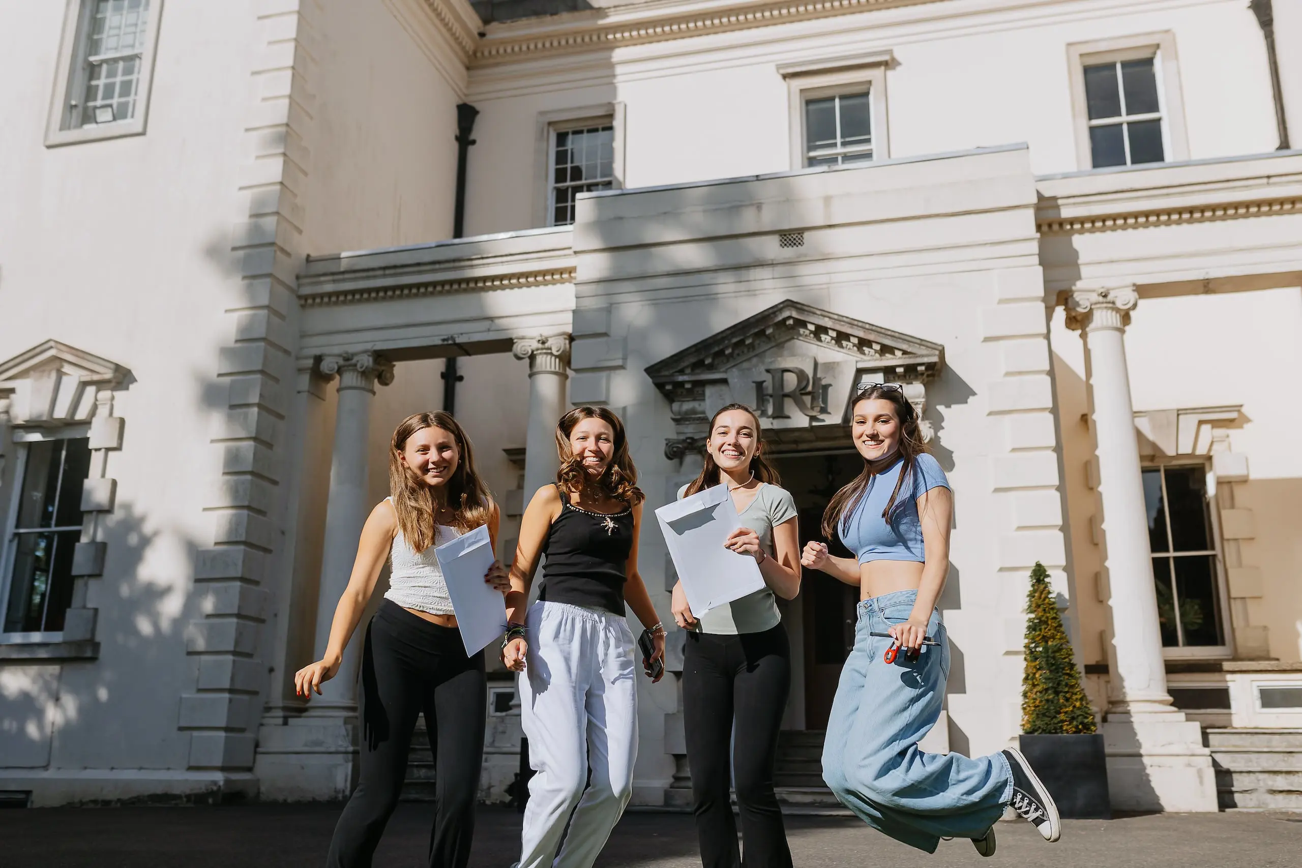 Students holding their exam results