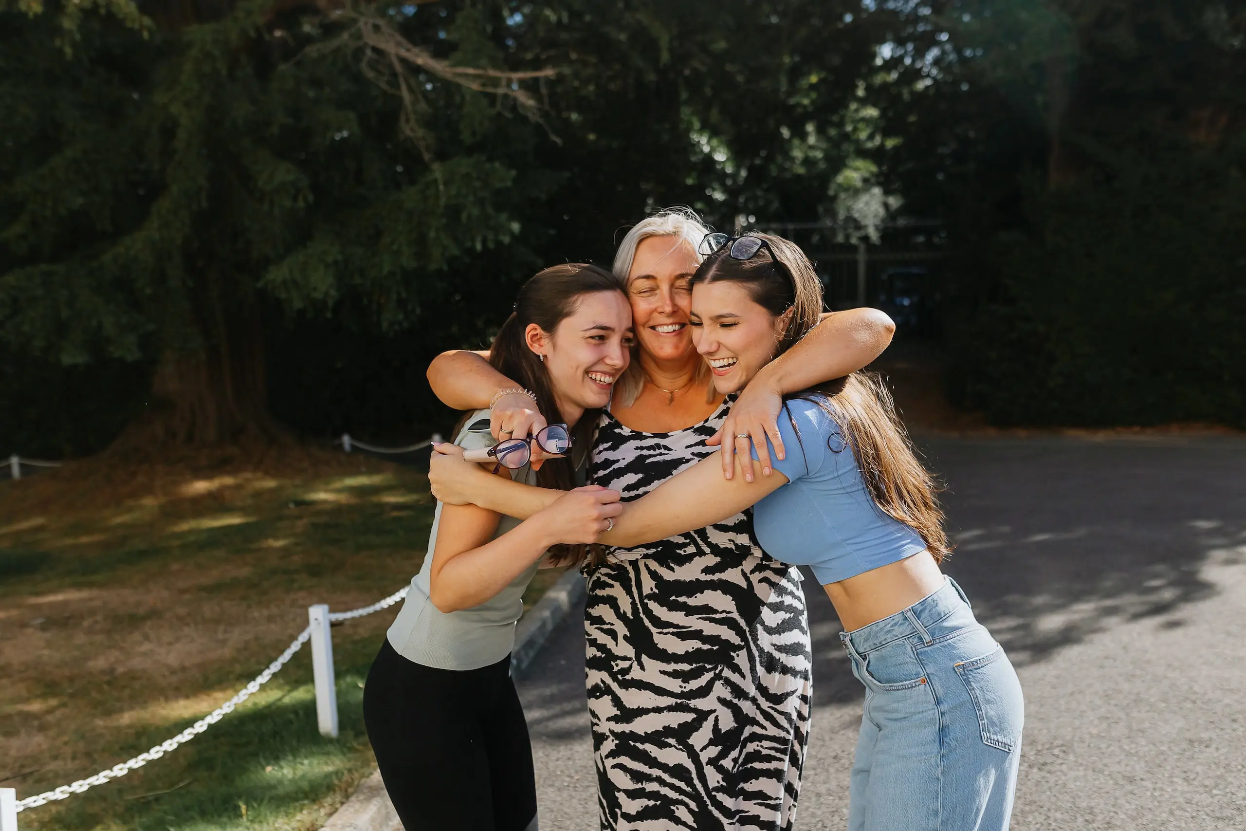 Students holding each other, smiling