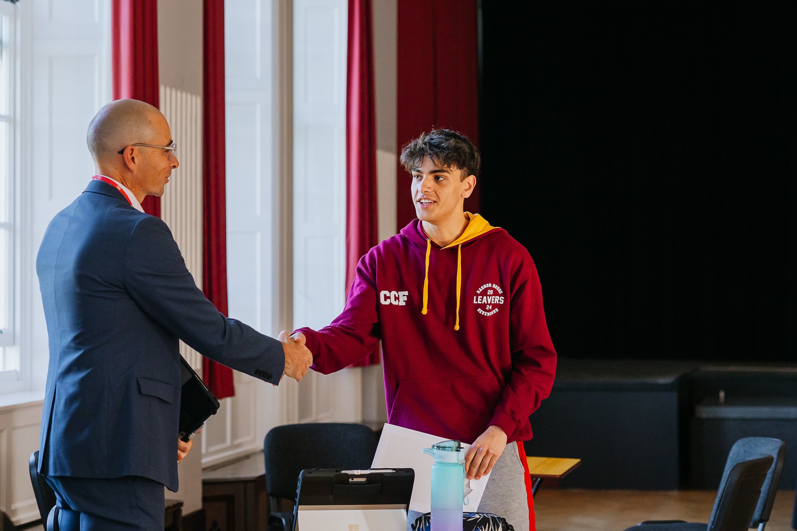 Student and teacher shaking hands