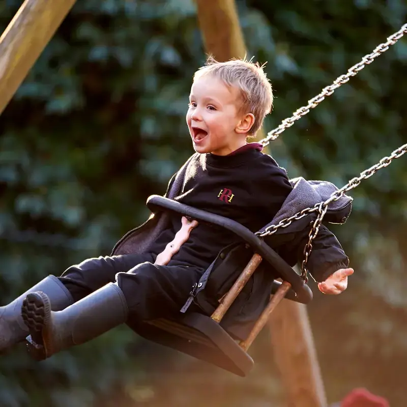 Radnor House Sevenoaks pupil playing on a swing