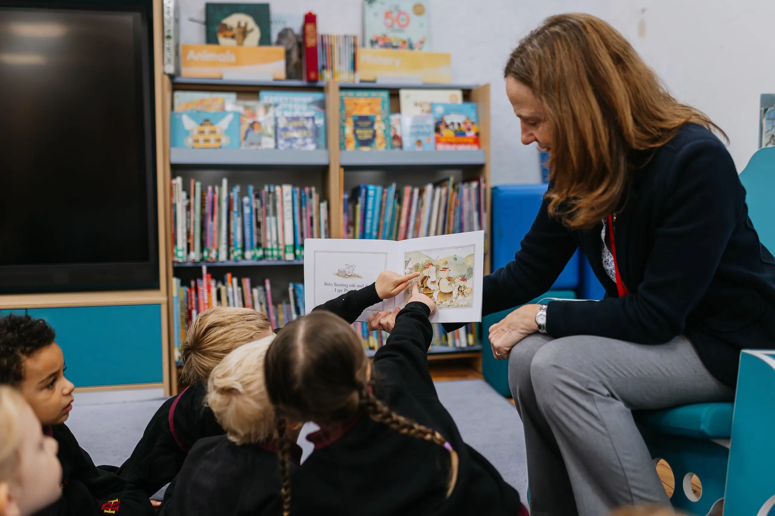 Teacher and students interacting with storybook