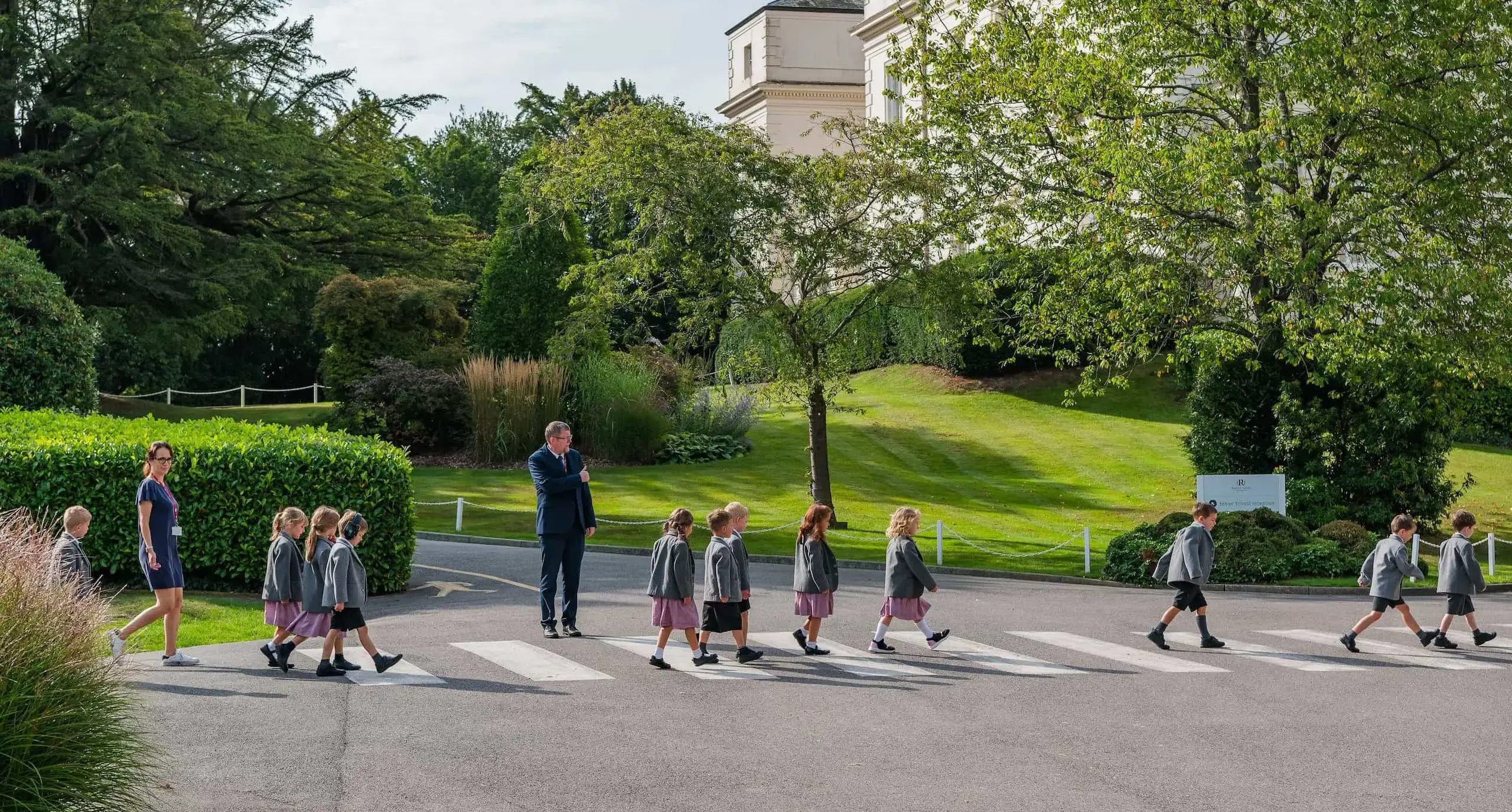 Radnor students crossing a zebra crossing with teacher supervision