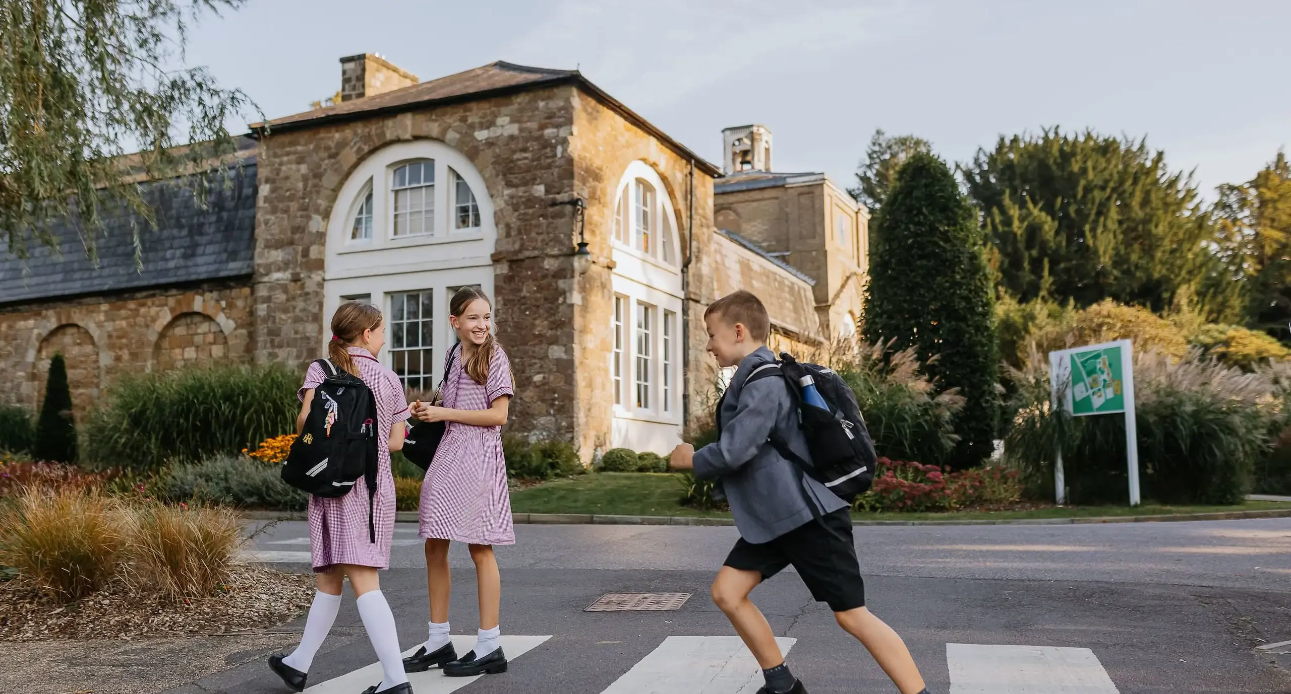 Students walking over a zebra crossing at the end of the school day