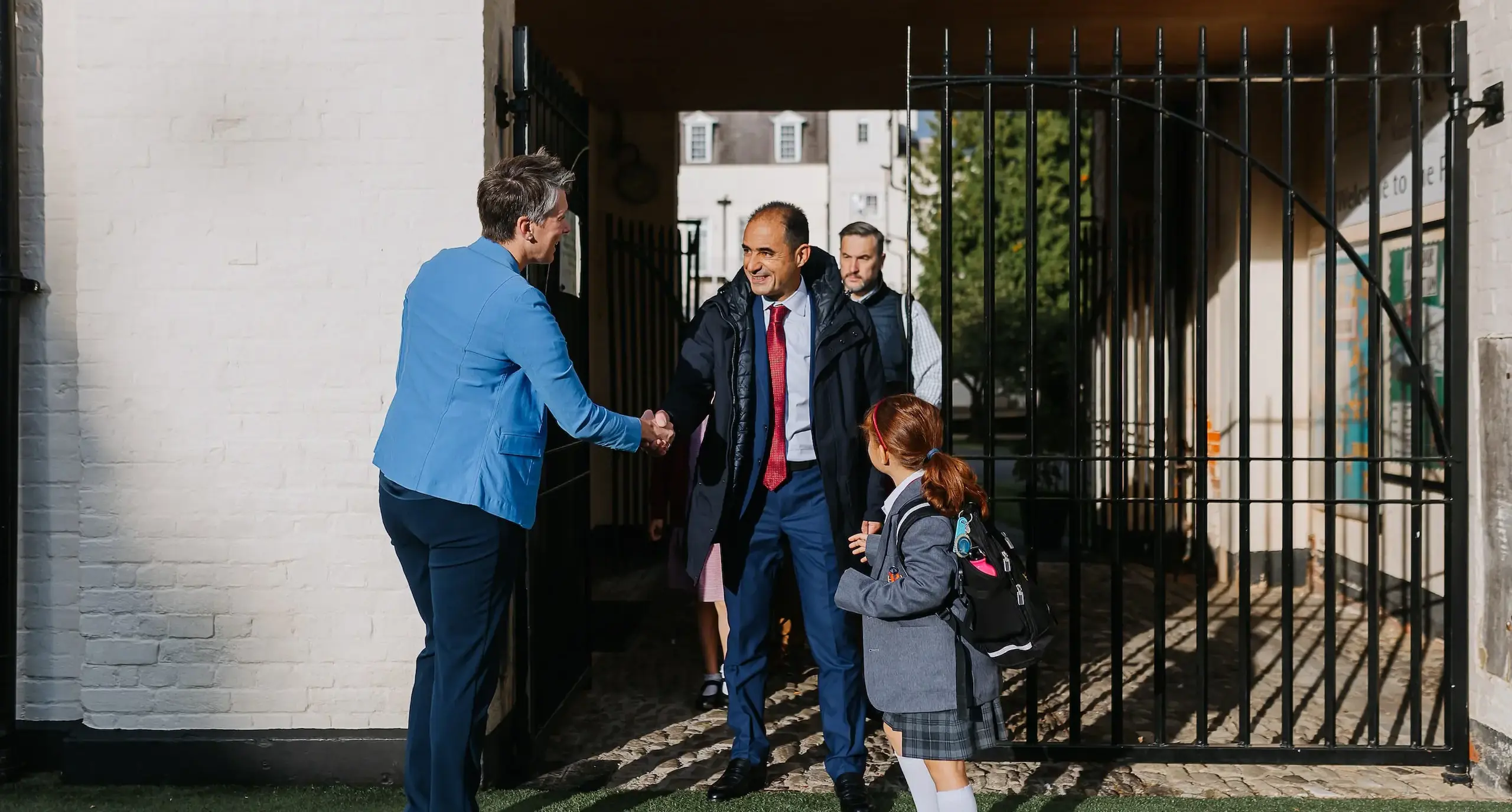 Teacher and parent shaking hands at Radnor gates