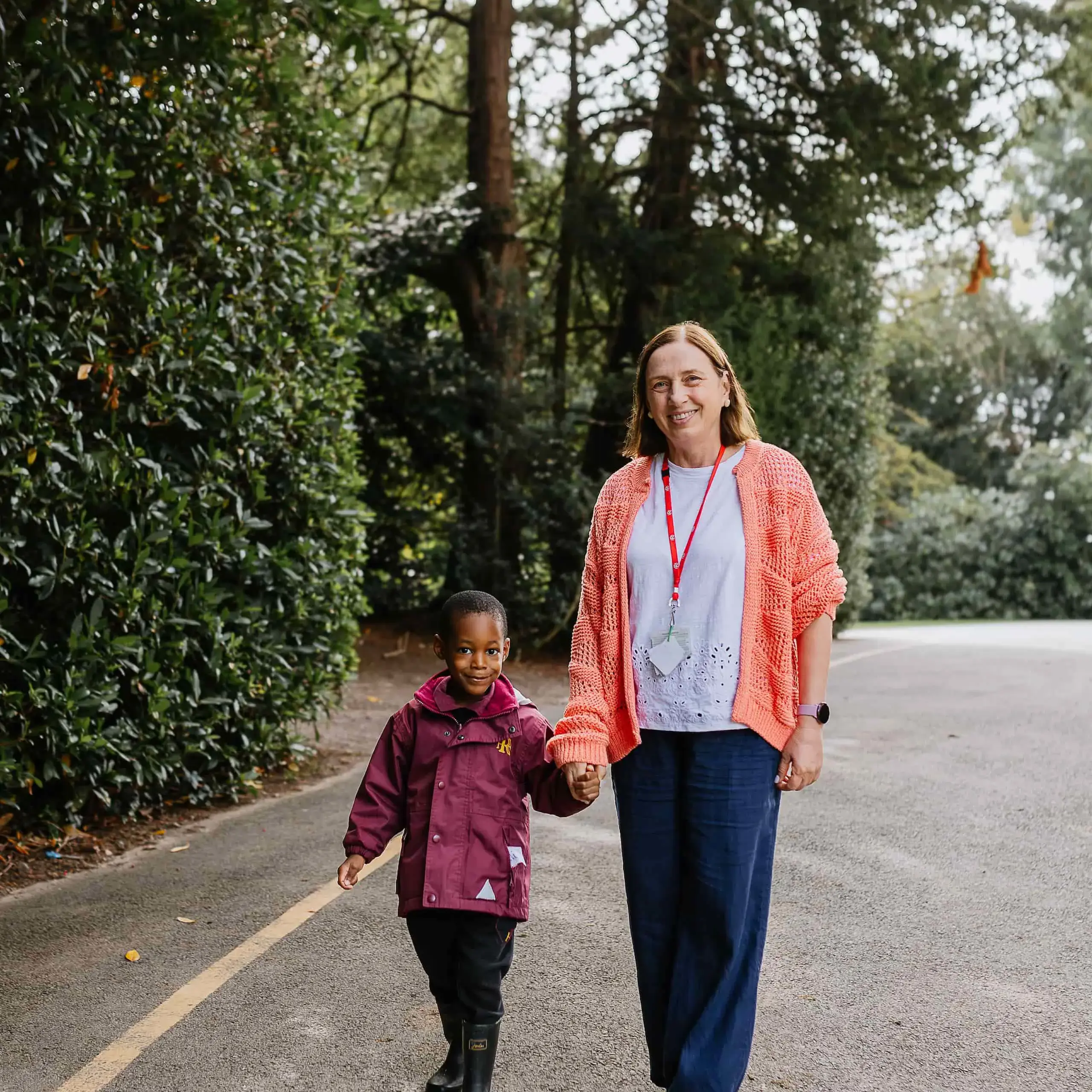 Teacher holding hands with student