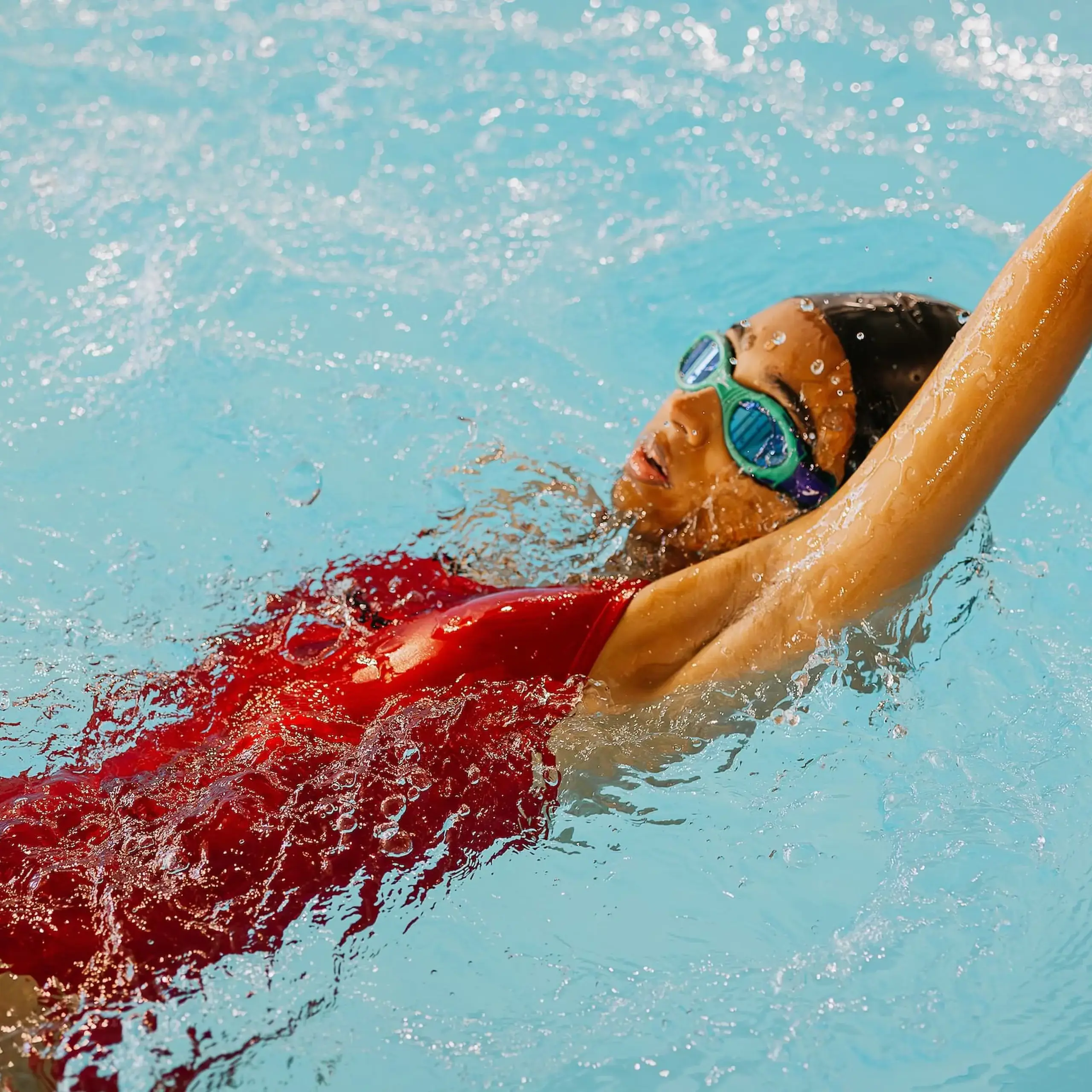 Backstroke swimmer moving through a pool