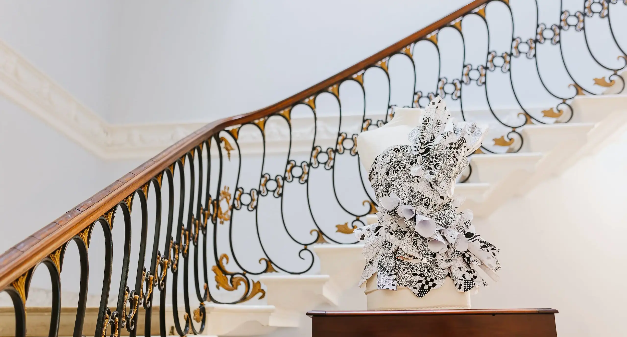 A staircase with a filligree-detailed bannister