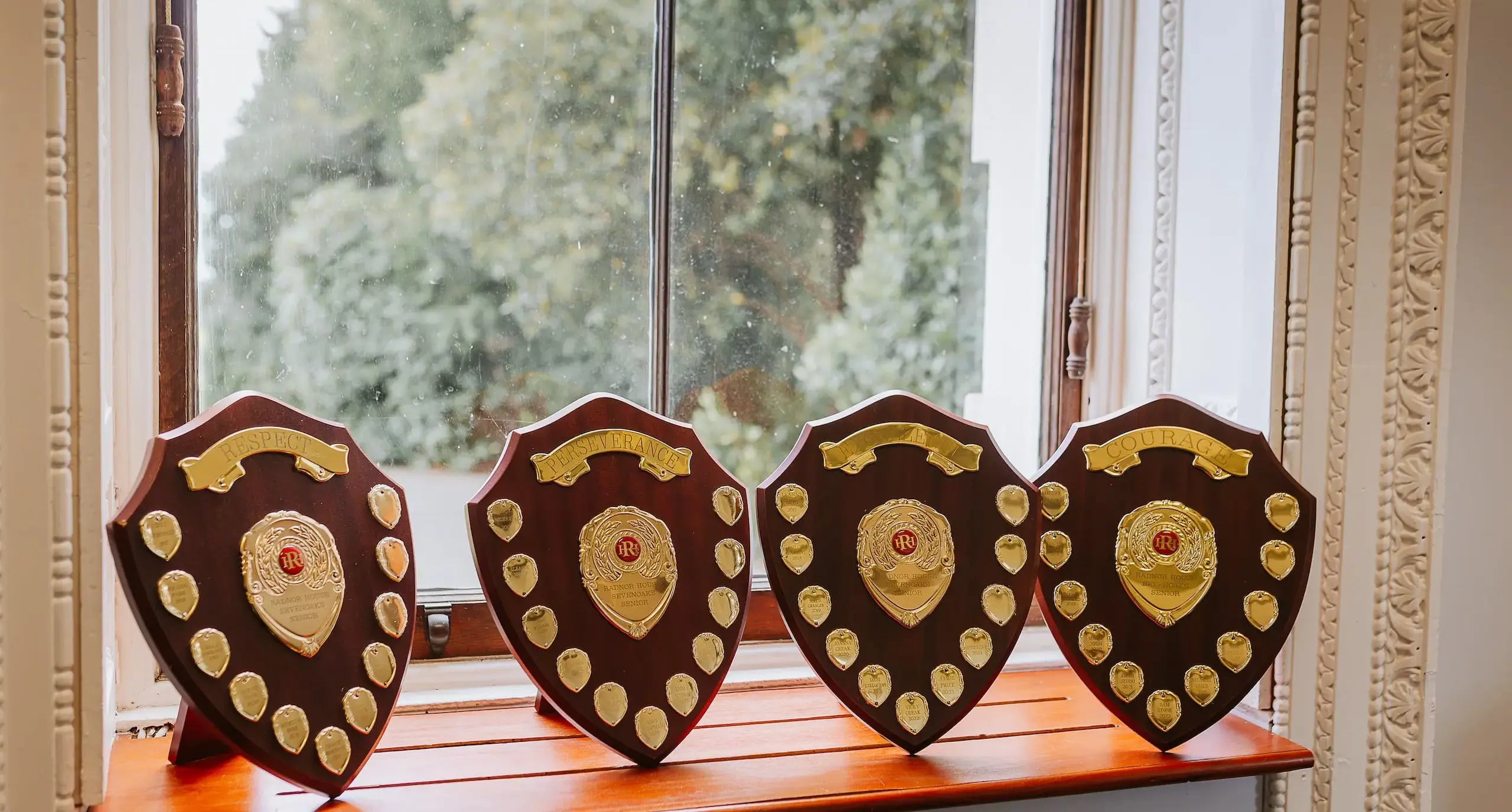 Senior school award shields on a windowsill